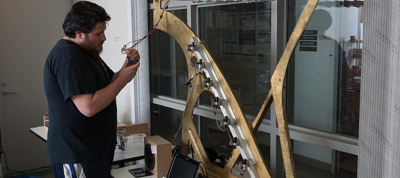 A student working on a laser harp