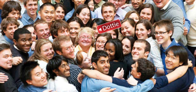 Dottie Welch smiling at the camera surrounded by adoring students.