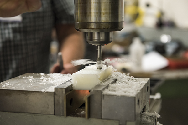 A close up of a machine drilling into material.