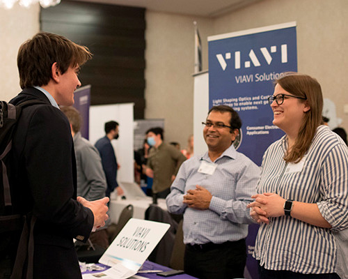 A student speaking to industry representatives at the spring 2022 symposium.