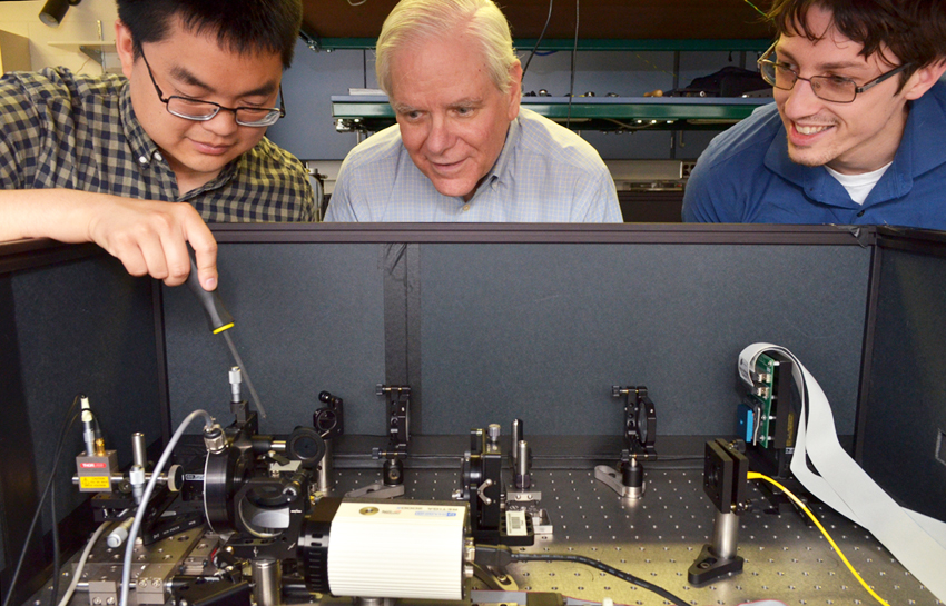 James Fienup and two PhD candidates working on a project in his lab.