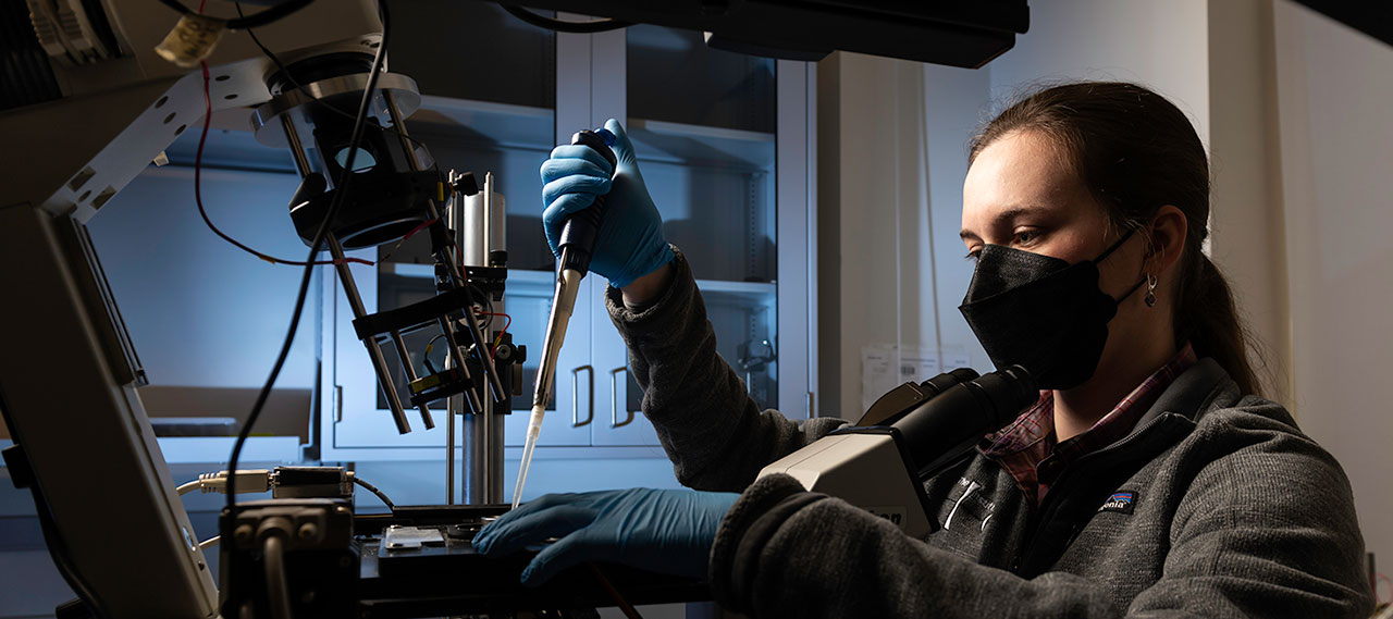 A graduate student prepares samples for imaging cells using a quantitative phase microscope to measure angularly resolved light scattering from single cells in order to size organelle distributions, in the lab of optics professor Andrew Berger.