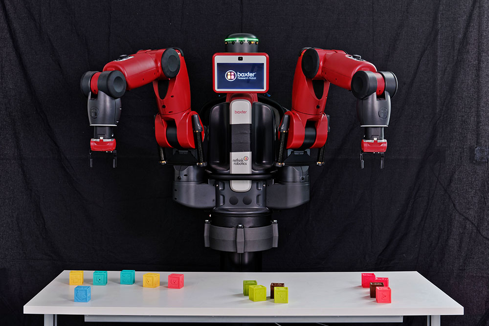 A robotic arm chooses between colored shapes.