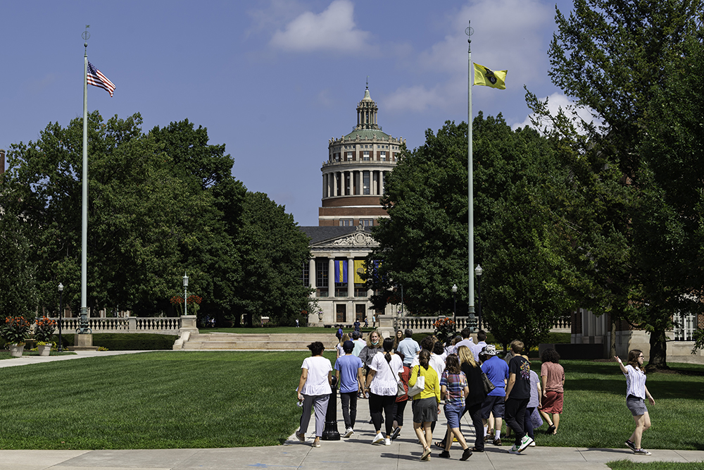 A group of students heading to the Eastman Quad during a campus tour.