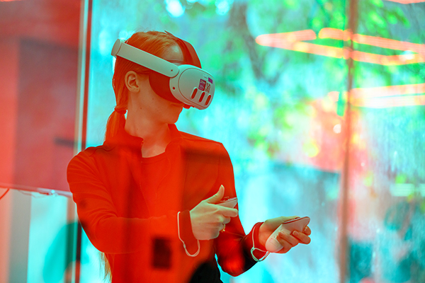 A colorized photo of a person using VR goggles.
