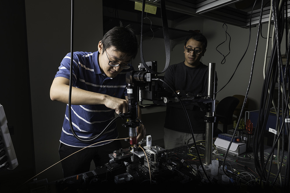 Students working with a laser in a lab.