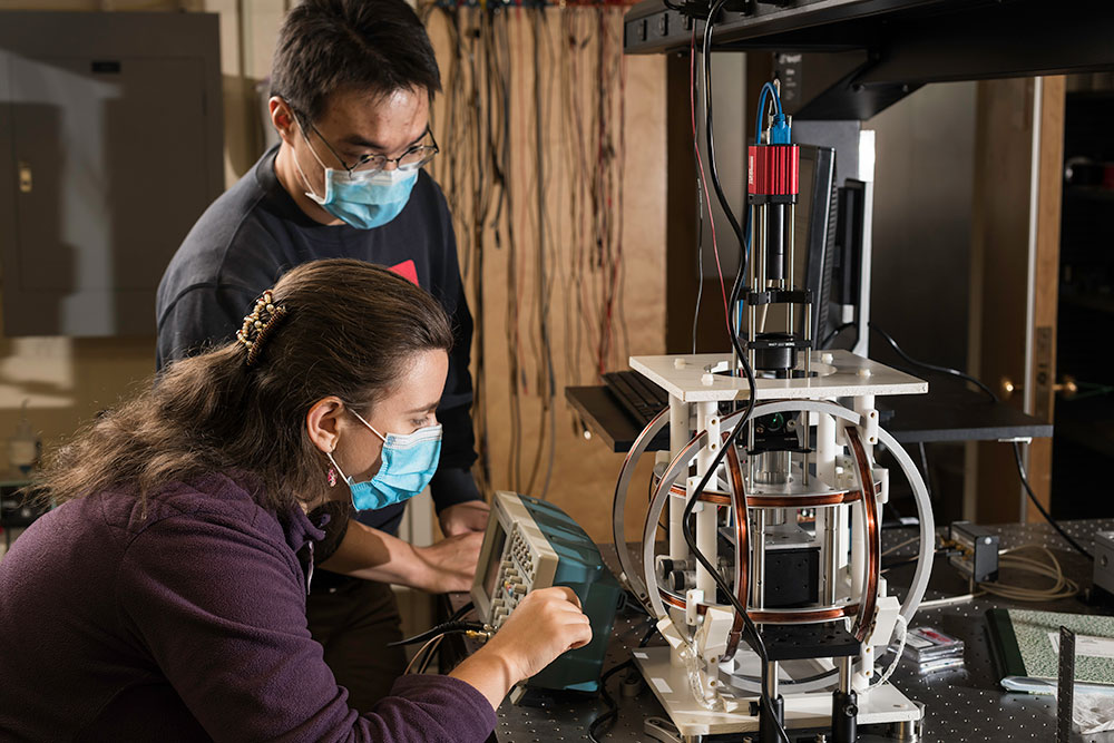 University of Rochester students are pictured with equipment in a lab.