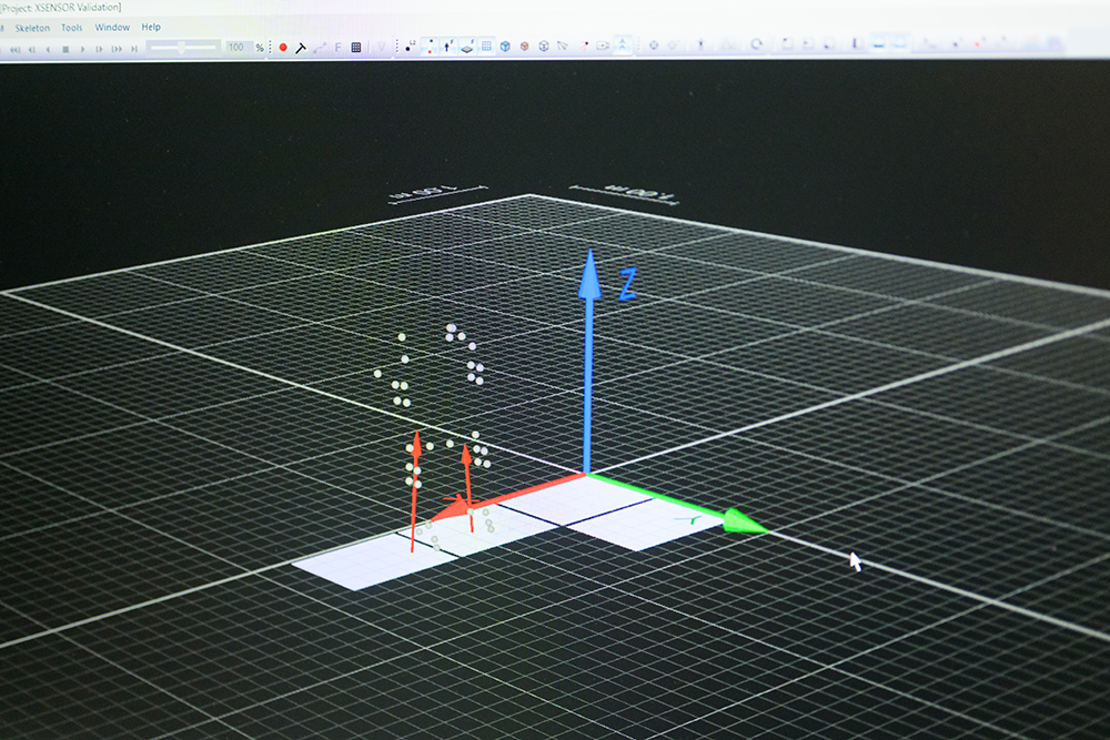 Computer display showing graphics and data from a suit outfitted with reflective markers for use in collection of biomechanics data.