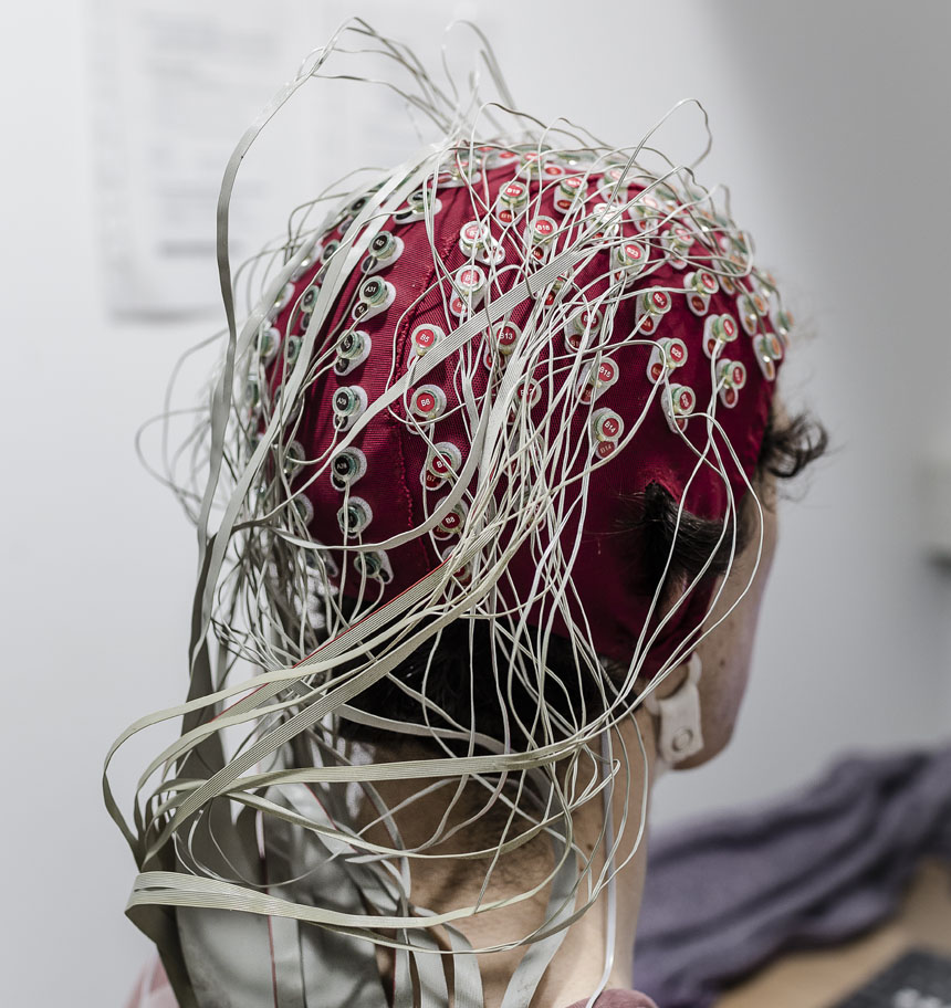 Test subject wears EEG monitoring device on scalp.