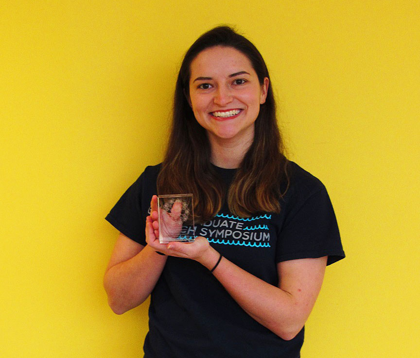 Bianca holds her award from Gulf Coast Research Syposium