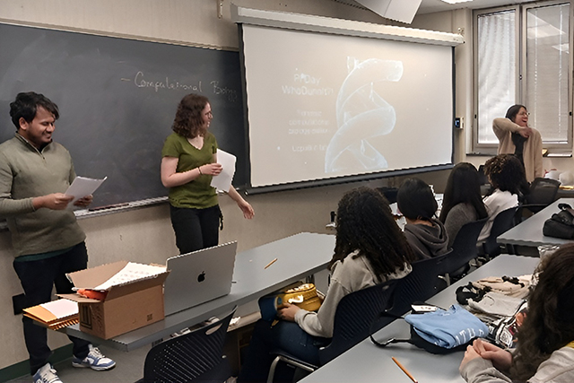 A group of three students giving a presentation in class.