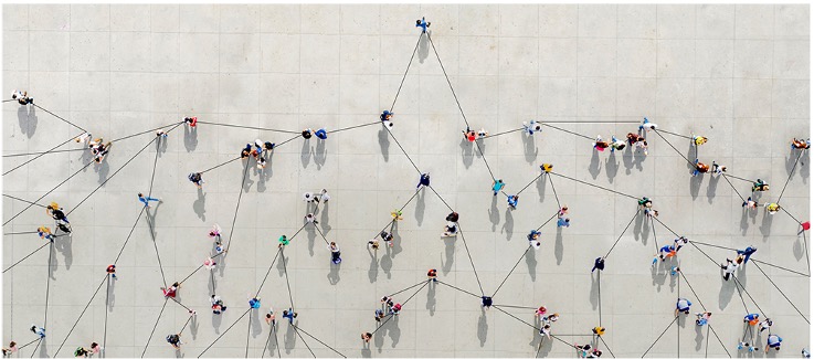 An overhead view of a group of inter-connected people.