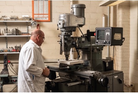 A technician working at a machine.