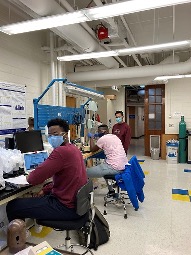 Three students working at computers.