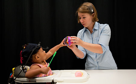 professor working with toddler