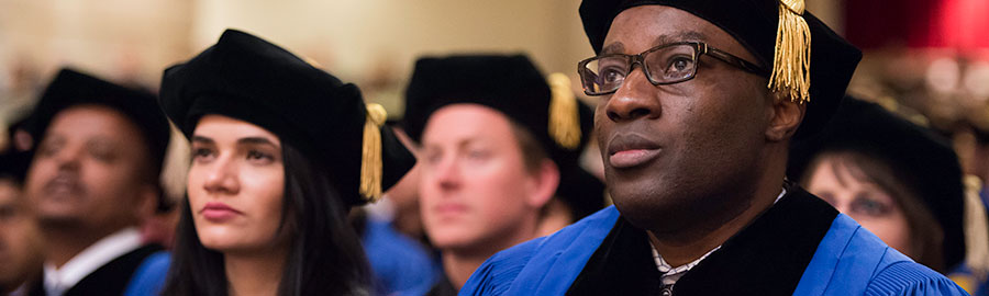 Graduates at a doctoral degree ceremony.