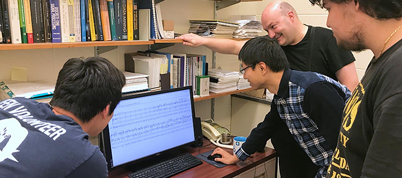 Students working around a computer.
