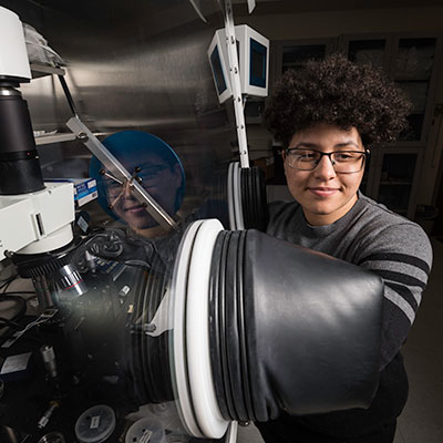 An graduate student working in a lab.