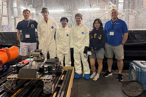 Team photo of students standinging with lunabot
