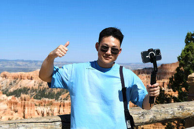 Man smiling at camera with a rocky canyon in the background