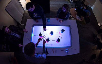 Students experient with an augmented reality table.
