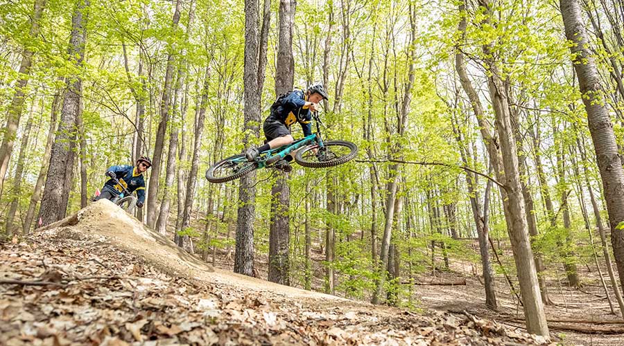 Nils Kingston ’21 riding trails on his mountain bike on a trail.