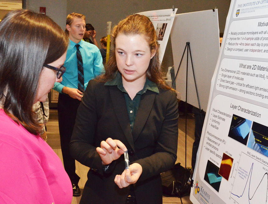 Catherine Arndt explains her project at a poster session