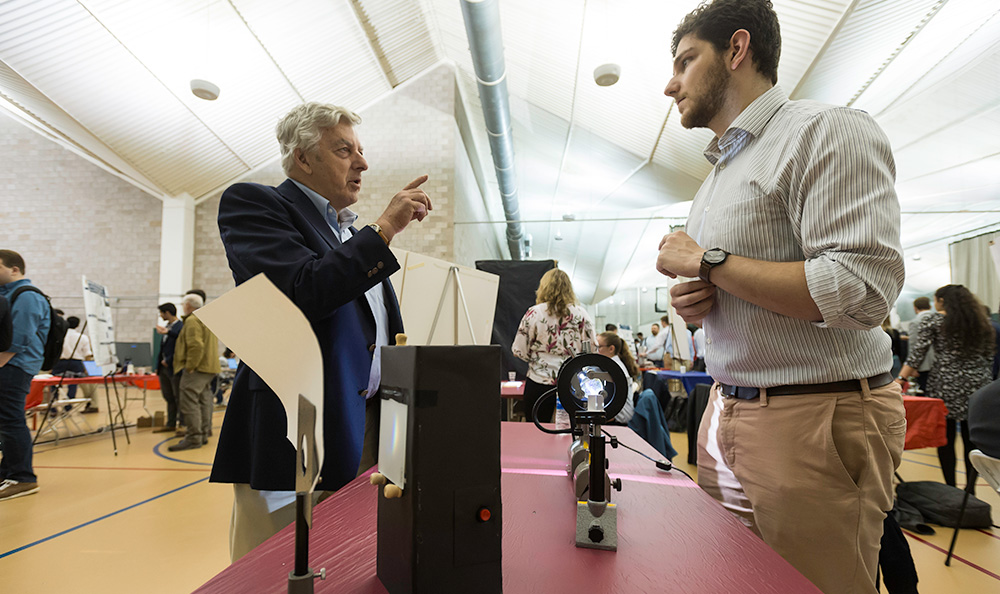 Visitor’s committee member Ted Miller, left, speaks with Ryan Walton ’19 at the annual Hajim Design Day.