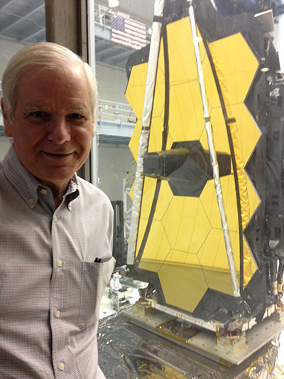James Fienup standing in front of the James Webb Space Telescope in 2017, just before it left Goddard Space Flight Center for testing at Johnson Space Center. 