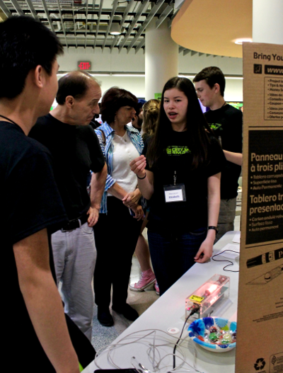 High school student presenting her poster.