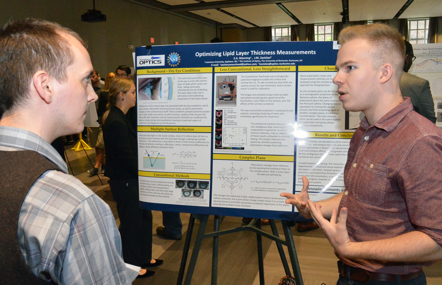 Zach Manning describes his project at a poster session.