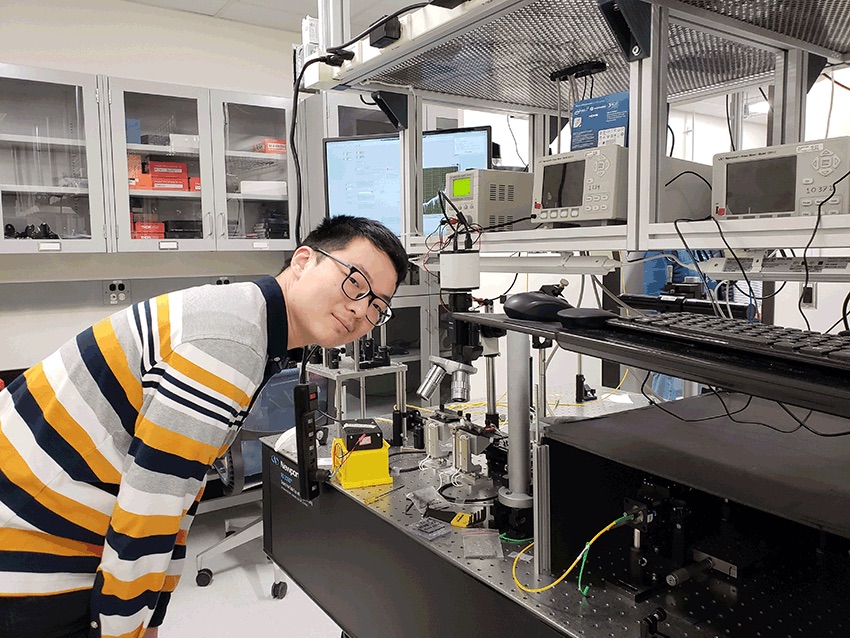 Yi checking a setup in the lab