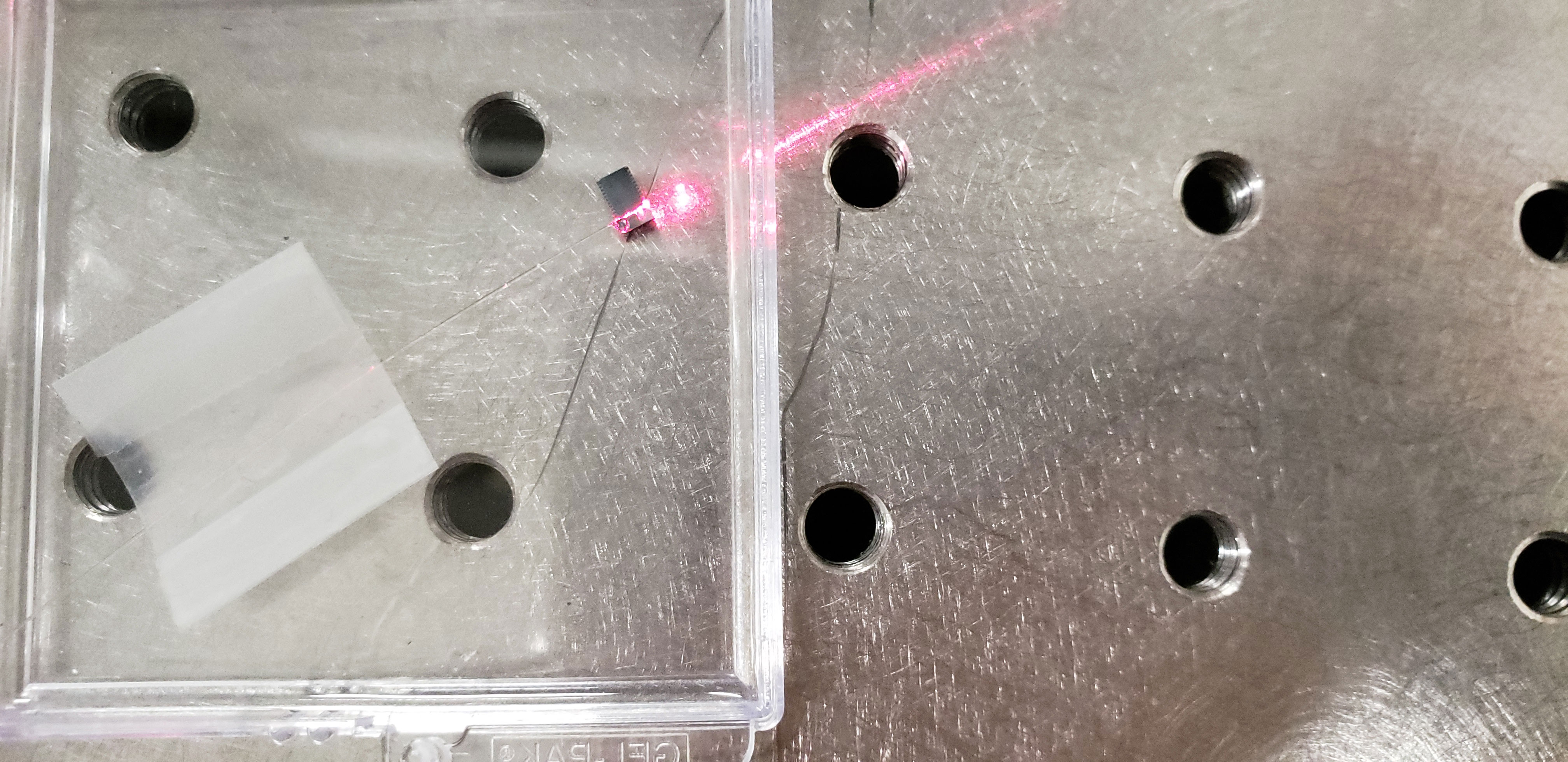 Red laser coming from Juniyali's chip fused to a fiber.