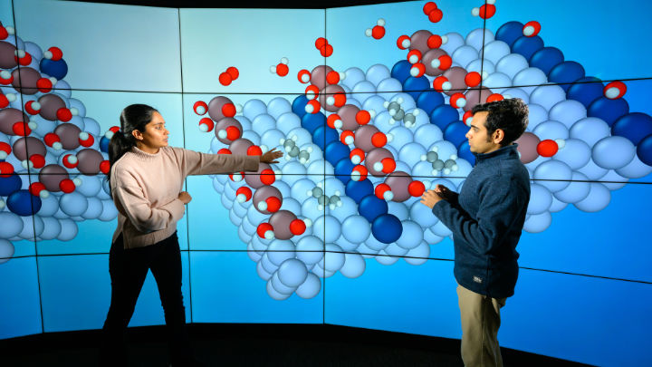 Assistant Professor Siddharth Desphande (R) and 3rd year PhD student Snehitha Srirangam are photographed at the VISTA Collaboratory with models depicting what happens on an atomic level when catalysts are used to turn shale gas into polypropylene.