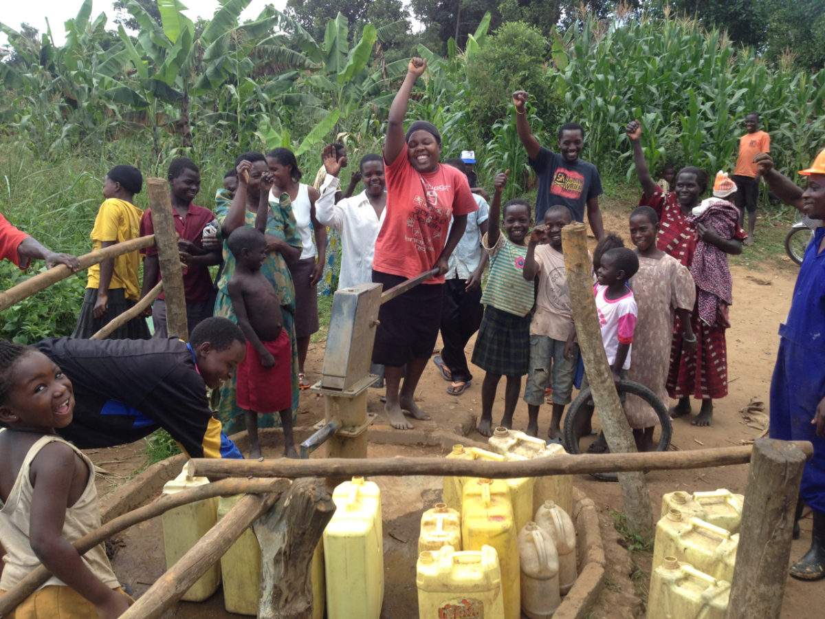 A photo of a Ugandan community using the India Mark II hand pump